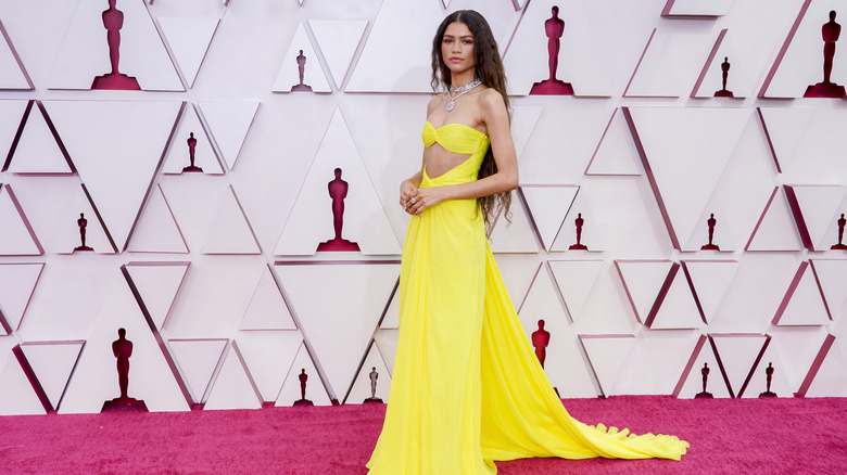 Zendaya posing in yellow gown at the Oscars