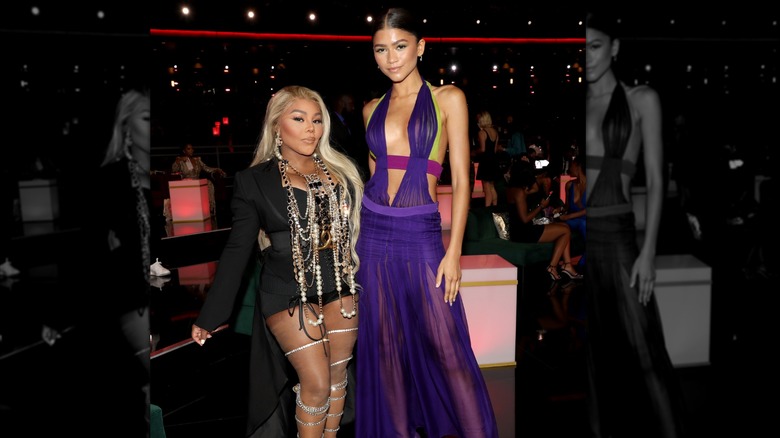 Zendaya in purple Versace dress beside Lil Kim