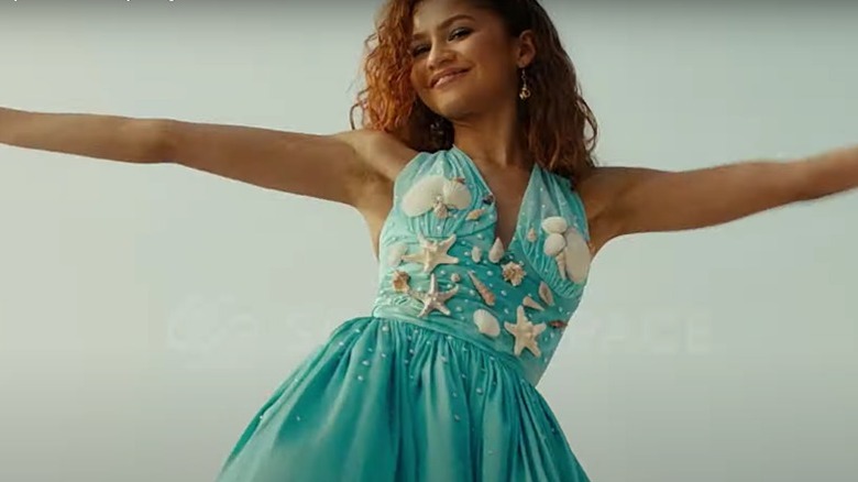 Zendaya smiling in a blue dress