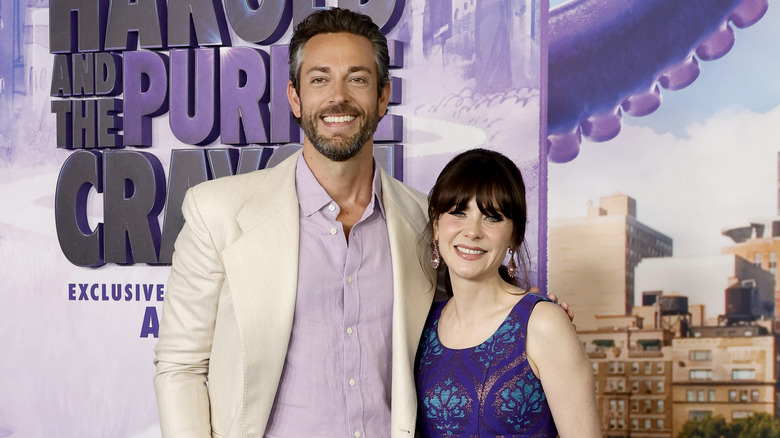 Zachary Levi and Zooey Deschanel posing at a movie event together